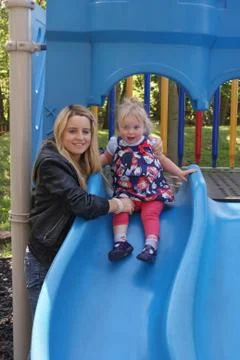 Child on Blue Slide Stock Photos