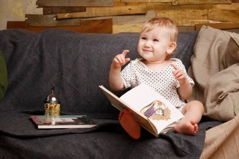 Child with a book Stock Photos