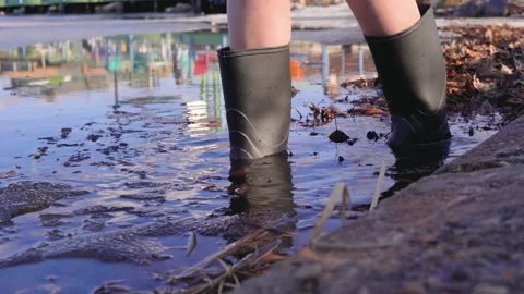 Child In Boots Walking In A Lake In Spring Stock Footage 172041253
