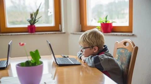 Child bored while brother play games on computer Video stock 44410755