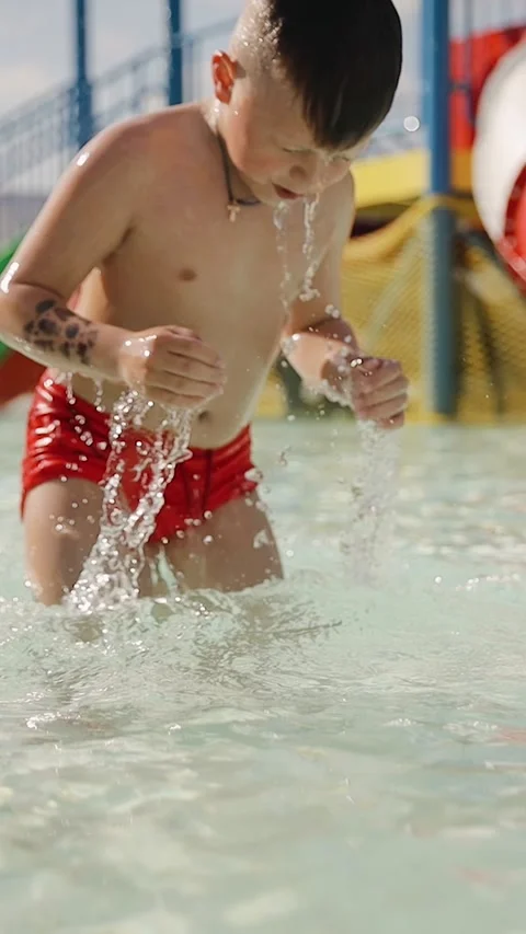Child boy 7 years old holding a breath and dives in swimming pool Stock Footage 278473129