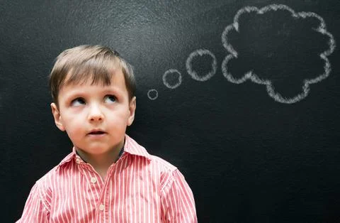 Child, boy and thinking with thought bubble on blackboard for creative idea Stock Photos