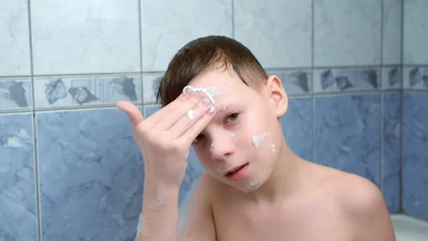 Child boy is applying alginate mask lying in bathroom with foam at home. Stock Footage 158847169