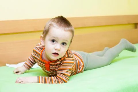Child boy on bed Stock Photos