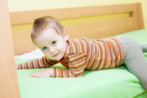 Child boy on bed Stock Photos