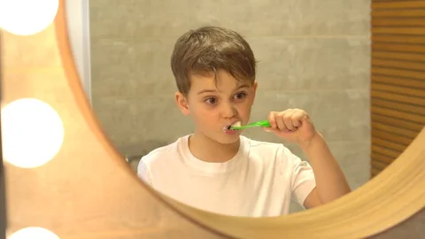 Child boy brushing teeth in bathroom Stock Footage 128778106