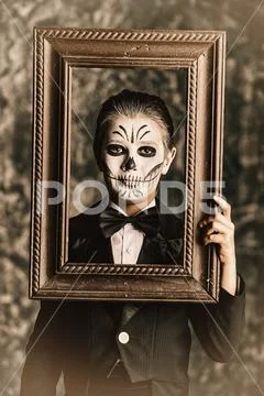 Child boy with carnival make-up of skeleton Stock Photos