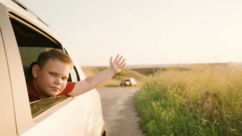 Child boy catching wind with hand, child sitting child car seat, children Stock Footage 278491085