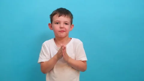 Child boy clapping hands to show approval. Young kid applauding and looking at Stock Footage 340407503