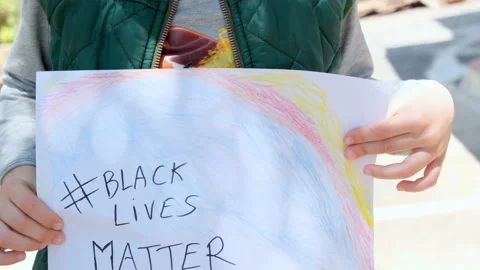 Child boy hold a paint for support black lives matter protest in usa,no racism Stock Footage 132286513