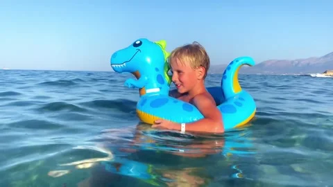 Child boy on inflatable float ring swimming enjoying in sea.Summer vacation,heal Stock Footage 340087057