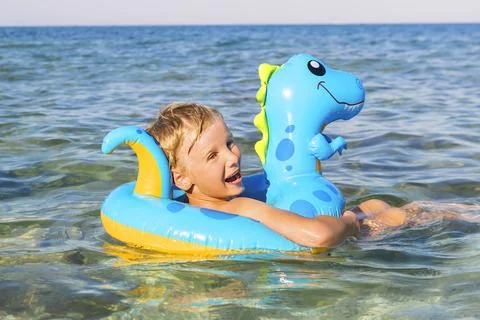 Child boy on inflatable float ring swimming enjoying in sea.Summer vacation Foto stock
