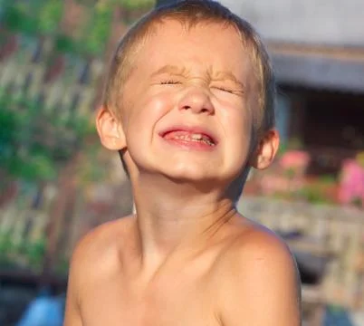Child boy making sore crying faces showing calf's teeth decay dental problems Stock Photos