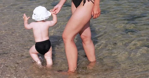 Child boy with mom on the beach Video stock 114265257