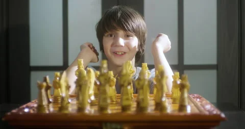 Child boy playing chess and thinking about chess move. Stock Footage 149320486
