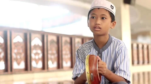 Child boy playing rabana or tambourine at mosque Stock Footage 170775221