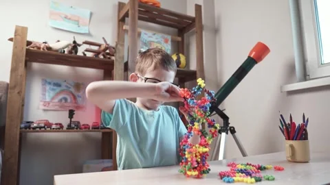 Child boy is playing with toy constructor for teaching the science of chemistry Stock Footage 277967902
