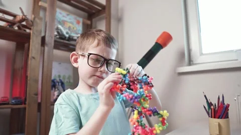 Child boy is playing with toy constructor for teaching the science of chemistry Stock Footage 277967916