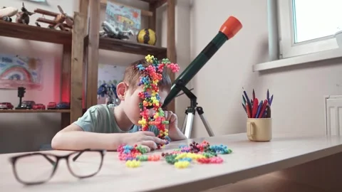 Child boy is playing with toy constructor for teaching the science of chemistry Stock Footage 277967972