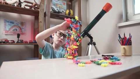 Child boy is playing with toy constructor for teaching the science of chemistry Stock Footage 277968009