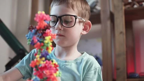 Child boy is playing with toy constructor for teaching the science of chemistry Stock Footage 277968047