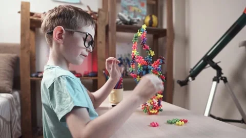 Child boy is playing with toy constructor for teaching the science of chemistry Stock Footage 277968212