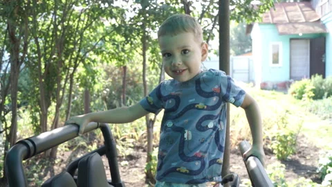 Child boy playing in the yard of the house Stock Footage 129095007