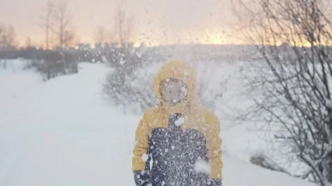 A child boy plays in winter throwing snow Stock Footage 293555042