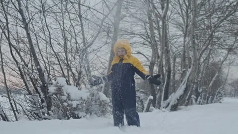A child boy plays in winter throwing snow Stock Footage 293555902