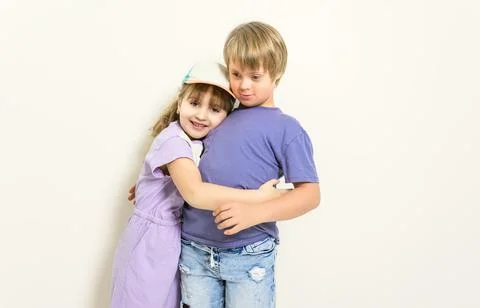 Child boy posing on studio white background with sister Stock-Fotos