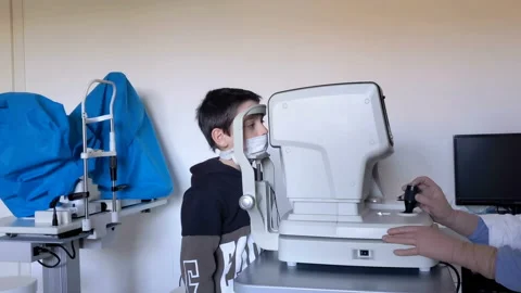 Child boy with protective face mask while doing ophthalmologist eyes sight exams Stock Footage 146755532