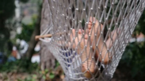 Child boy is resting in hammock in garden, in sunny summer day. Stock Footage 238367653