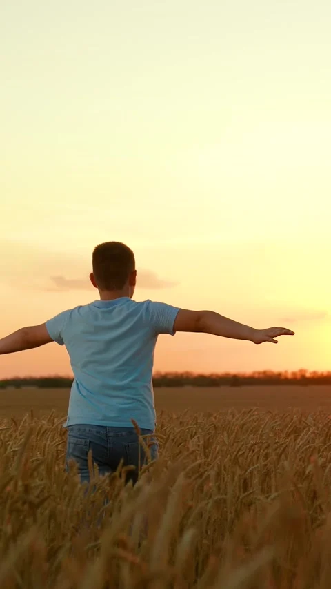 Child boy running with raised hands, dream to fly on plane. Boy run through Stock Footage 322194575