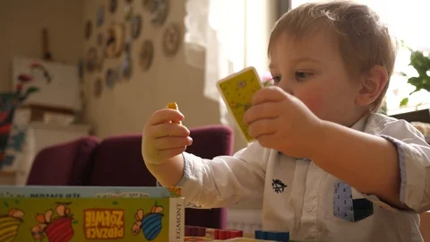 Child boy sit at the table play board games at home Stock Footage 87546954