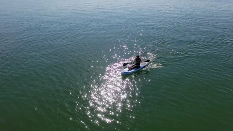 Child boy sitting on paddleboard. Stock Footage 113946070