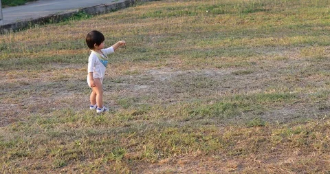 Child boy toddler running exercise relaxation in park with grass playground Stock Footage 86341474