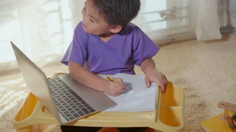 Child boy using a laptop study online lesson at home Stock Footage 146627477