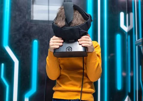 Child boy using virtual or augmented reality glasses. Concept of modern Stock Photos