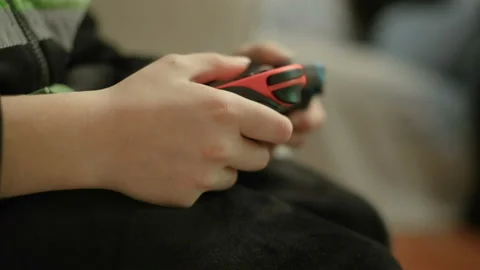 Child boy while playing with portable videogames console,tech kids addiction Stock Footage 167980559