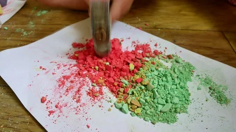 The child breaks the crayons with a hammer. The girl crumbles the colored crayon Stock Footage
