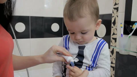 A child is brushing his teeth in front of a mirror. Stock Footage 161504955