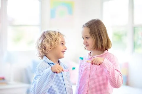 Child brushing teeth. Kids with toothpaste, brush. Stock Photos