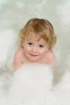 Child in a bubble bath Stock Photos