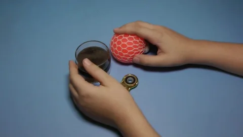Child bugging in the hands of a soft ball on the blue background. Stock Footage 83011304