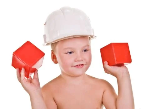 Child a builder.boy with red blocks Stock Photos