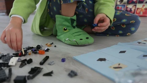 Child Building a New Interlocking Plastic Bricks Toy Stock Footage 123494084