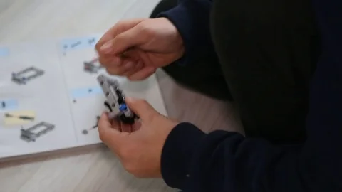 Child building a new interlocking plastic bricks toy Stock Footage 123497390