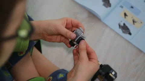 Child building new interlocking plastic bricks toy Stock Footage 123507524