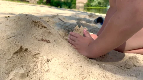 Child building sandcastle on beach Stock Footage 303519879