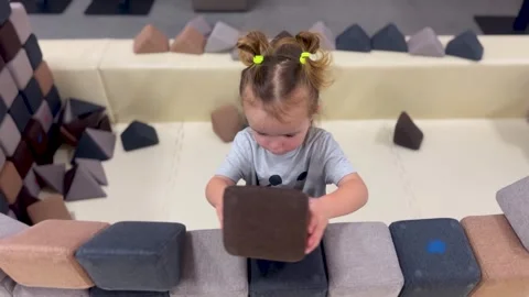 Child Building Soft Foam Blocks Wall in Indoor Playground Stock-Footage 331748090